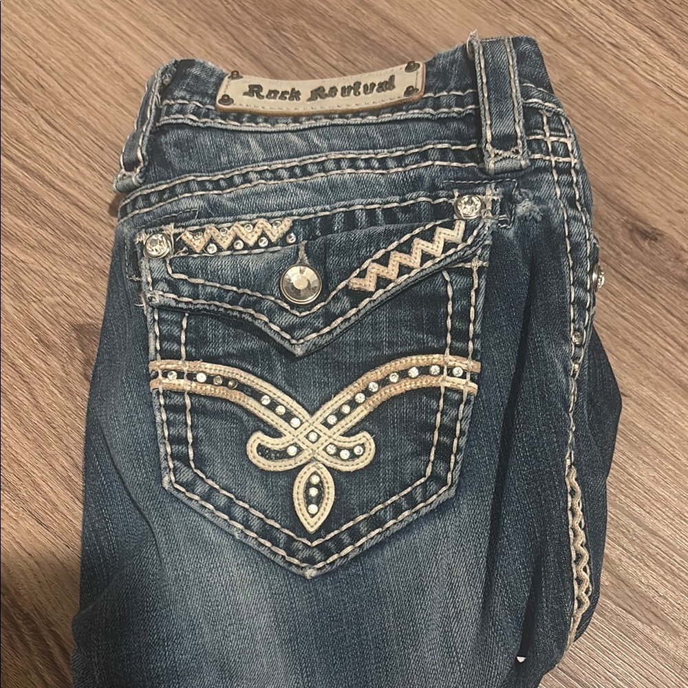 Rock Revival Blue Boot Cut Jeans with Ornate Back Design